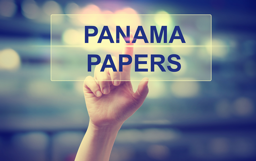 Digital graphic reading Panama Papers with a hand touching a glowing interface